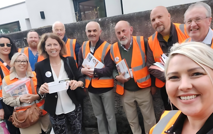 a group of people in safety vests standing next to each other